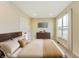 Cozy bedroom with comfortable bed, wooden dresser, and a large window for natural light at 7604 Brownstone Ct, Greenfield, IN 46140