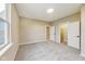 Neutral bedroom with natural light, carpet, and two closets with white doors at 7604 Brownstone Ct, Greenfield, IN 46140