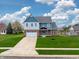 Beautiful two-story home with brick and light blue accents, set on a lush green lawn at 7604 Brownstone Ct, Greenfield, IN 46140
