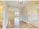 Bright hallway with hardwood floors and arched doorway leading into a spacious living area at 7604 Brownstone Ct, Greenfield, IN 46140