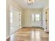 Entryway featuring hardwood floors, neutral walls, and a clear view to the front door at 7604 Brownstone Ct, Greenfield, IN 46140