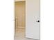 A door opens to the carpeted hallway of the home with white trim, doors, and neutral walls at 7604 Brownstone Ct, Greenfield, IN 46140