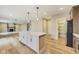 Beautiful kitchen featuring a white island and hardwood floors leading into the living room at 7604 Brownstone Ct, Greenfield, IN 46140