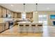 Stylish kitchen with a white center island, stainless steel appliances and modern lighting fixtures at 7604 Brownstone Ct, Greenfield, IN 46140