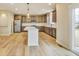 Bright kitchen featuring stainless steel appliances, a center island, and sliding glass doors to the backyard at 7604 Brownstone Ct, Greenfield, IN 46140