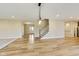 Hardwood floors in a living room with an arched entryway and a view of the foyer and staircase at 7604 Brownstone Ct, Greenfield, IN 46140