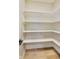 Walk-in pantry with ample shelving and hardwood floors at 7604 Brownstone Ct, Greenfield, IN 46140