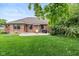 Expansive backyard featuring a well-maintained lawn, mature trees, and a brick home exterior at 767 Harvest Ridge Dr, Avon, IN 46123