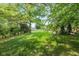 Secluded backyard featuring mature trees, a well-manicured lawn, and a black fence for privacy at 767 Harvest Ridge Dr, Avon, IN 46123
