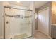 Bathroom featuring a glass-enclosed tiled shower and patterned tile flooring for a luxurious experience at 767 Harvest Ridge Dr, Avon, IN 46123