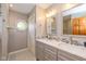 Bright bathroom featuring a dual sink vanity with gray cabinets and a decorative mosaic tile backsplash at 767 Harvest Ridge Dr, Avon, IN 46123
