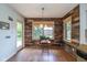 Cozy dining area with wood paneling and natural light from multiple windows at 767 Harvest Ridge Dr, Avon, IN 46123