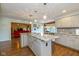 Spacious kitchen island with granite countertop, pendant lighting, and views to dining area and living room at 767 Harvest Ridge Dr, Avon, IN 46123