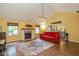Bright living room with a fireplace, large rug, vaulted ceiling, and a view to the kitchen at 767 Harvest Ridge Dr, Avon, IN 46123