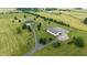 Expansive aerial view of the property, highlighting the well-maintained home, lush greenery, and outbuilding at 7702 N County Road 300 W, Lizton, IN 46149