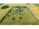 Aerial shot of a home and expansive, well-maintained yard surrounded by agricultural fields at 7702 N County Road 300 W, Lizton, IN 46149