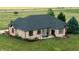 Aerial view of backyard patio with outdoor dining set and lush landscaping at 7702 N County Road 300 W, Lizton, IN 46149