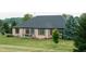 Backyard view of patio with outdoor dining set and well-manicured lawn at 7702 N County Road 300 W, Lizton, IN 46149