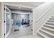 Basement room featuring home gym equipment, neutral paint, and stairwell access at 7702 N County Road 300 W, Lizton, IN 46149
