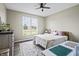 Well-lit bedroom with wood floors, a large window, a ceiling fan, and neutral-toned walls at 7702 N County Road 300 W, Lizton, IN 46149