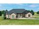 Charming brick home with manicured lawn and mature trees, offering a picturesque and welcoming curb appeal at 7702 N County Road 300 W, Lizton, IN 46149