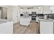 Beautiful kitchen with white cabinets, stainless steel appliances, and a stylish kitchen island at 7702 N County Road 300 W, Lizton, IN 46149