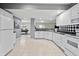 Bright kitchen with white cabinets, black countertops, tile backsplash, and open floor plan view at 7702 N County Road 300 W, Lizton, IN 46149