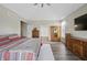 Large main bedroom with hardwood flooring, vaulted ceiling, and view to the main bathroom at 7702 N County Road 300 W, Lizton, IN 46149