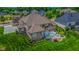 Aerial view of home with brick exterior, backyard seating, a well-kept lawn, and landscaping at 7845 Centerstone Ct, Indianapolis, IN 46259