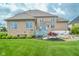 Well-maintained brick home featuring a backyard with an outdoor patio and seating at 7845 Centerstone Ct, Indianapolis, IN 46259