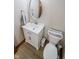 Small half bathroom featuring a modern vanity with a white countertop and a round mirror at 7845 Centerstone Ct, Indianapolis, IN 46259