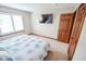 Inviting bedroom featuring a shuttered window, mounted TV and warm wood trim at 7845 Centerstone Ct, Indianapolis, IN 46259