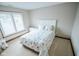 Cozy bedroom with white headboard, floral bedding, and natural light from the window at 7845 Centerstone Ct, Indianapolis, IN 46259
