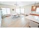 Dining room with a long table, modern chandelier, and large windows with coverings at 7845 Centerstone Ct, Indianapolis, IN 46259