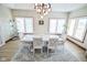 Bright dining room with white table set and large windows with wooden shutter coverings at 7845 Centerstone Ct, Indianapolis, IN 46259
