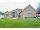 Charming brick home with manicured lawn, lovely landscaping, and a welcoming entrance at 7845 Centerstone Ct, Indianapolis, IN 46259