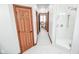 Hallway with marble-pattern flooring leads to the bathroom with a walk-in shower at 7845 Centerstone Ct, Indianapolis, IN 46259