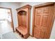 Mudroom hallway featuring a custom wooden hall tree with bench seating and storage at 7845 Centerstone Ct, Indianapolis, IN 46259