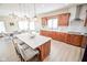 Bright kitchen with a large island with seating, wooden cabinetry, and stainless steel appliances at 7845 Centerstone Ct, Indianapolis, IN 46259