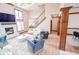 Bright and open living room featuring a fireplace, staircase, and elegant decor at 7845 Centerstone Ct, Indianapolis, IN 46259