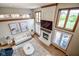 Bright living room featuring a fireplace, large windows with beautiful views, and hardwood floors at 7845 Centerstone Ct, Indianapolis, IN 46259