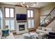 Elegant living room with a fireplace, modern lighting, and ample natural light at 7845 Centerstone Ct, Indianapolis, IN 46259