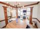 Open-concept living room with wood trim, chandelier, fireplace and large windows at 7845 Centerstone Ct, Indianapolis, IN 46259
