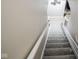 Carpeted staircase with a white railing, offering access to multiple levels at 7845 Centerstone Ct, Indianapolis, IN 46259
