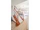 Elegant staircase with carpeted steps and a dark metal railing leading to the main living area at 7845 Centerstone Ct, Indianapolis, IN 46259