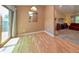 Bright dining room with hardwood floors and backyard deck access, located beside the living room at 7846 Park North Cir, Indianapolis, IN 46260