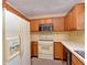 Kitchen area featuring classic wood cabinets and white appliances at 7846 Park North Cir, Indianapolis, IN 46260