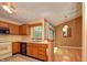 Traditional kitchen featuring wood cabinets, white appliances, and a view to the dining area at 7846 Park North Cir, Indianapolis, IN 46260