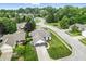 An aerial view shows a home in a quiet neighborhood, showcasing its manicured lawn and mature trees at 7914 Trotwood Cir, Indianapolis, IN 46256