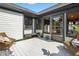 Spacious back deck featuring white floors and railings, wicker chairs and an entrance to the sunroom at 7914 Trotwood Cir, Indianapolis, IN 46256